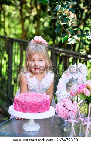Little girl celebrate Happy Birthday Party with rose decor in the beautiful garden