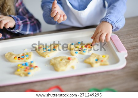 little kids baking funny colorful cookies