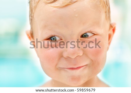 portrait of smiling sly cute boy having a fun closeup