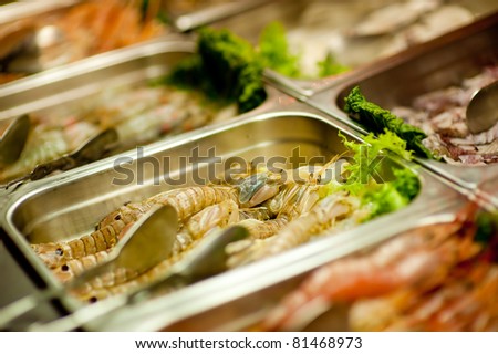 a lot of raw shrimps on a seafood buffet