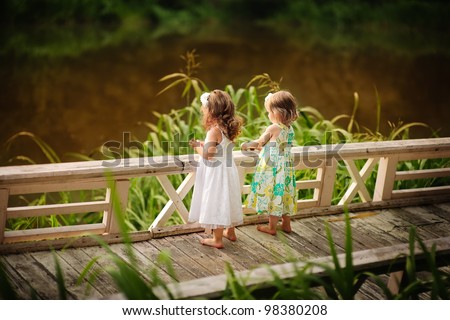 Group of two cute little flower girl in the beautiful garden