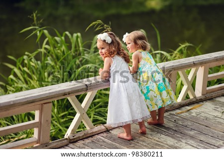 Group of two cute little flower girl in the beautiful garden