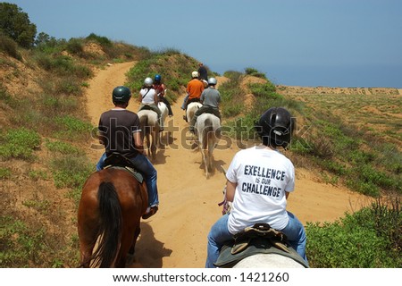 Excellence is our challenge - a group of novice riders walking towards sea