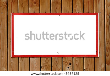 Blank warning sign with red frame on wooden wall