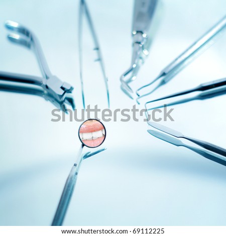 Angled mirror and dental instruments , beautiful smile reflection , shallow depth of field