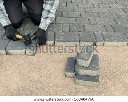 Paver laying driveway pavement out of concrete pavement blocks
