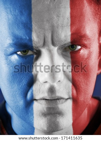 Closeup of young French supporter face painted with national flag colors