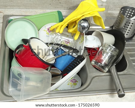 Kitchen sink full of dirty kitchenware