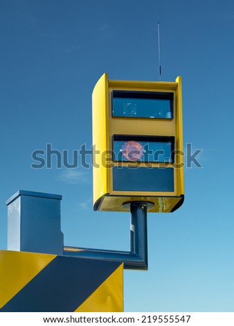 Traffic speed monitoring camera, against blue sky