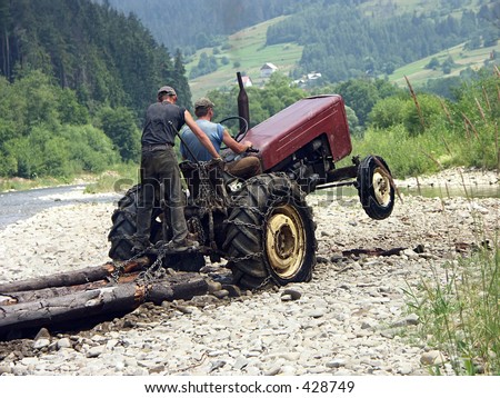Farm tractor hauling logs got stuck