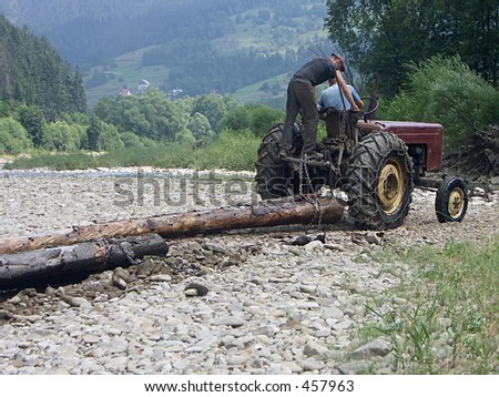 Farm tractor hauling logs