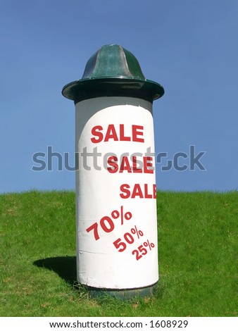 Advertising column with big sale notice