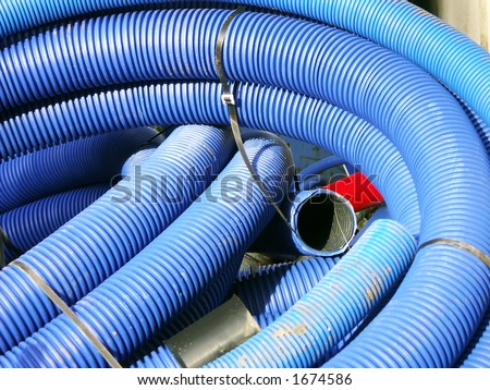 Coils of blue corrugated plastic pipes