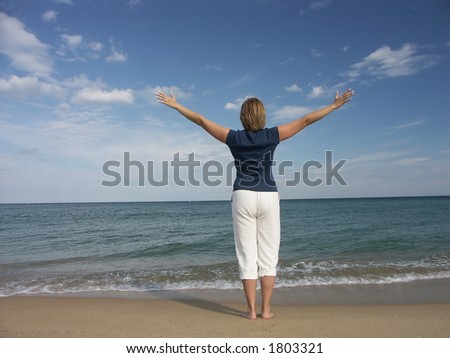 Girl standing at the beach expressing joy of life