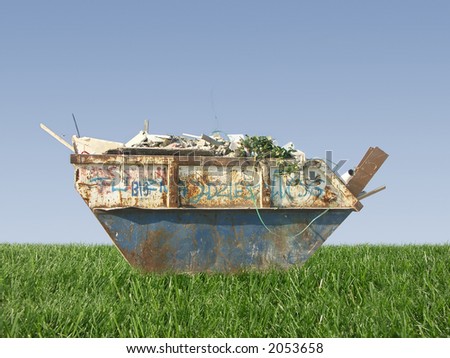 Metal waste container with building debris on grass against clear blue sky
