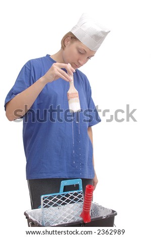 stock photo Girl wearing paper hat holding paintbrush soaked with white