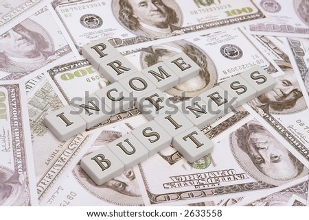 Letter pieces making a crossword composed of business, profit, income words - over US one hundred dollar bill background