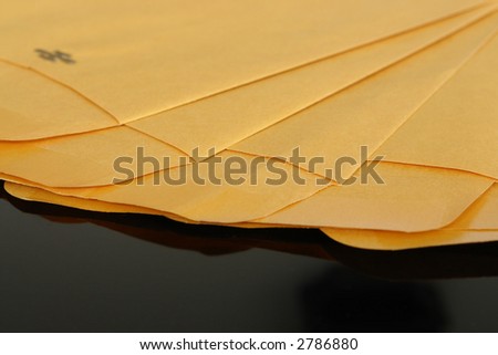 Array of yellow empty envelopes over black background