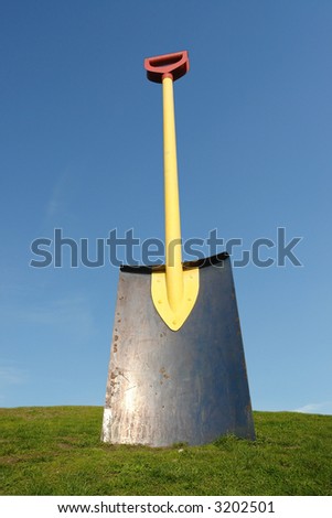 stock-photo-giant-shovel-driven-into-gra