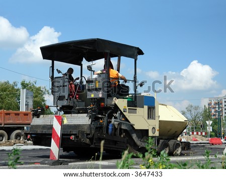 Two workers sitting in asphalt paving machine