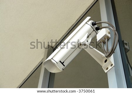 Security cctv camera fixed to office window frame