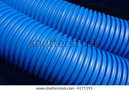 Closeup of two blue plastic corrugated plumbing pipes