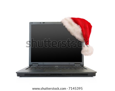 Black open laptop with red santa claus hat put on lcd corner - isolated on white