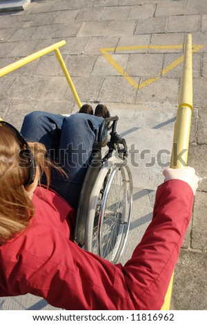 Closeup of wheelchair woman going down the concrete stairs