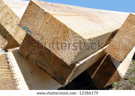 Timber for house rafter framing stacked on construction site