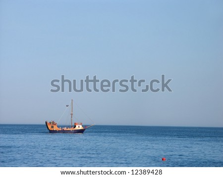 Tourist boat with holiday makers on board anchoring near the seashore