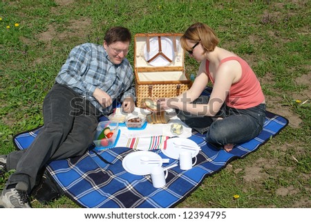 Young couple having picnic in the park