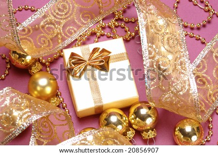 Christmas gift with golden decorations and ribbon