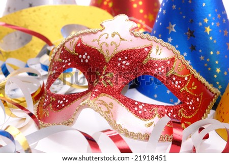 Closeup shot of Venetian mask, party hats and streamers