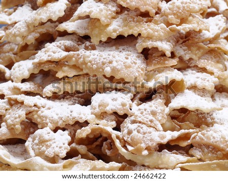 Closeup shot of traditional Polish sweet crispy biscuits called Faworki with caster sugar