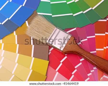 Paint brush on array of different paint color swatches