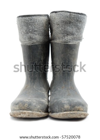 Dirty rubber-soled felt insulated boots shot over white