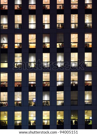 Office building exterior in the late evening with interior lights on