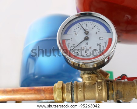 Temperature and pressure gauge mounted on boiler pipes
