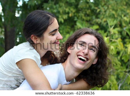 Young happy couple laughing outdoors