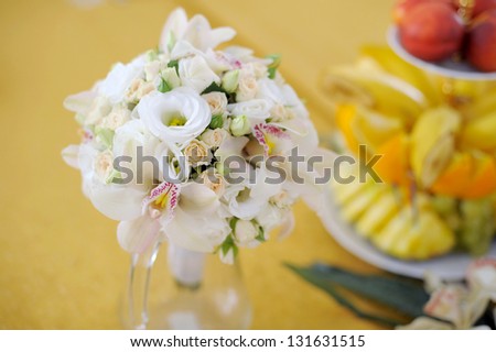 wedding rose and orchid bouquet on yellow background