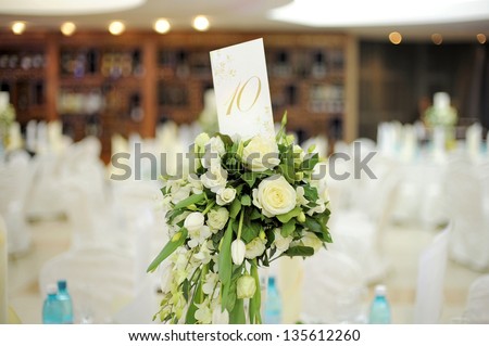 white rose bouquet with table number card