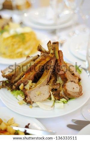 meat with bones on plate in restaurant