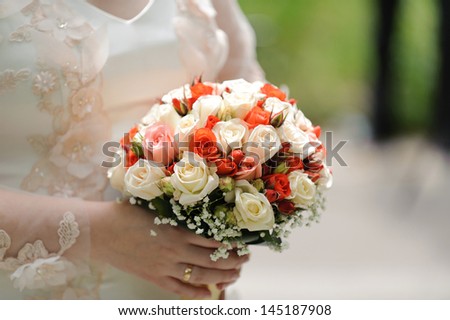 bride holding rose wedding bouquet