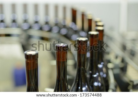 closeup of bottles at wine production line