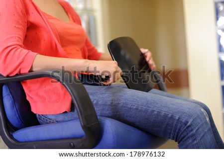 woman with mirror sitting in armchair