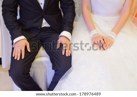 bride and groom sitting at wedding party