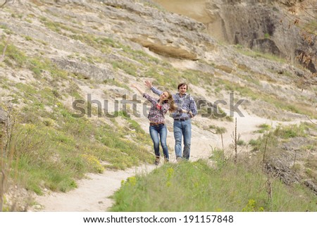carefree young people walking on rocky path