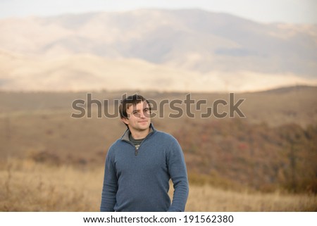 portrait of young man in field