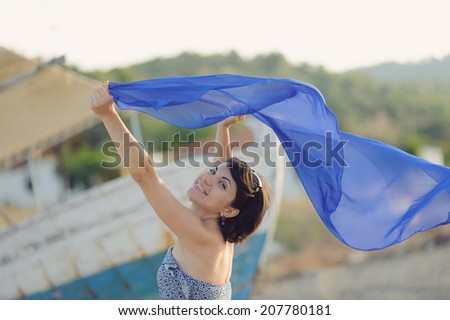 portrait of laughing woman with flying scarf