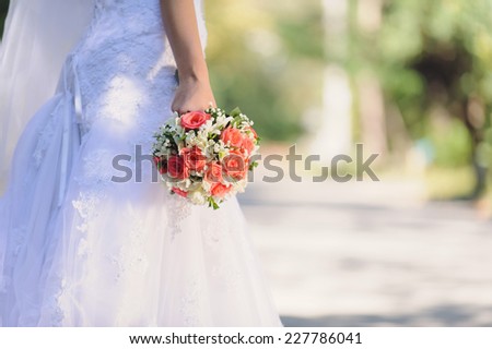 bride holding beautiful rose wedding bouquet
